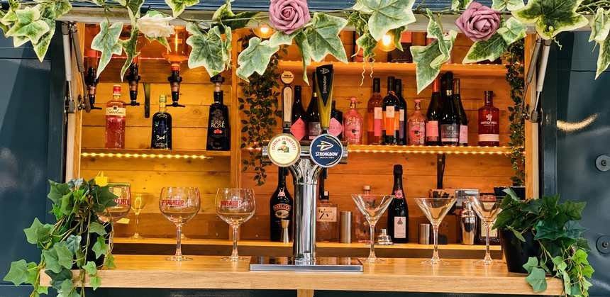 Inside the Horsebox Bar: draught taps and gin shelves
